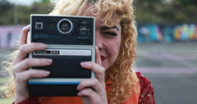 Young girl using vintage old camera outdoor