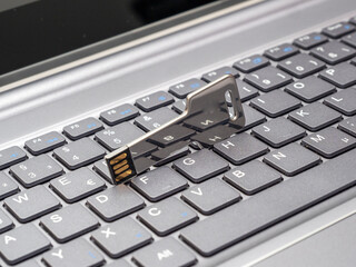 usb flash drive in the form of a key and a laptop.