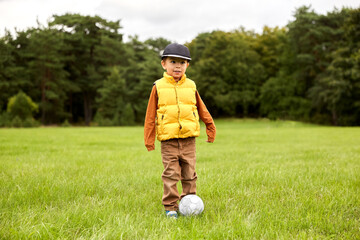 childhood, leisure games and people concept - little boy with soccer ball at summer park