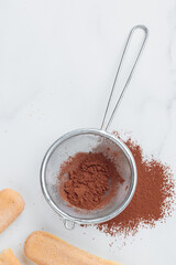 Tiramisu ingredients: Italian cookie savoiardi and cocoa powder