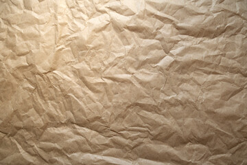 Kraft paper texture. Brown crumpled paper. Wrinkled kraft paper. It is used for background and texture. Background made of a closeup of a crumpled brown paper.