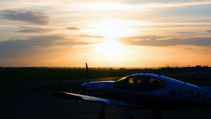 Fototapeta na wymiar Private airplane awaiting take off at sunset