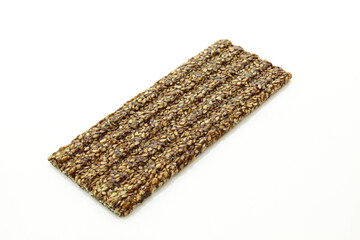 Sticky and crunchy bar with chocolate and sesame isolated on white background