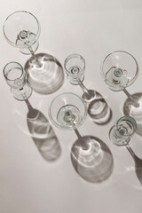 Cocktail glasses with long shadows on the table