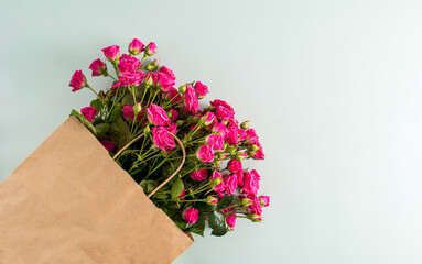 Top view of the large crafting package with roses for greetings on a blue background with a copy of the space.