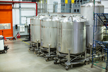 Stainless vertical steel tanks with equipment tank chemical cellar at the with scrolling wheel...
