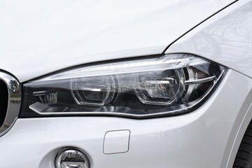 Fototapeta na wymiar Can Stock Photo Bright shiny headlight. Bright shiny car headlight close-up. new clean led car light