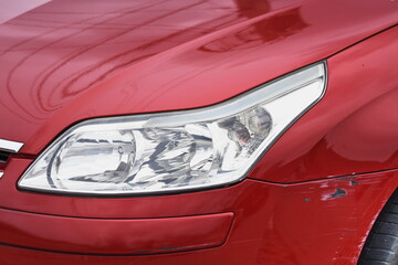shiny headlight on a  red car