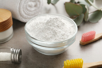 Obraz na płótnie Canvas Tooth powder, brushes and dental floss on grey table, closeup