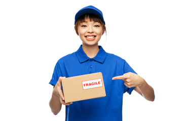profession, job and people concept - happy smiling delivery woman in blue uniform holding parcel box with fragile mark over white background