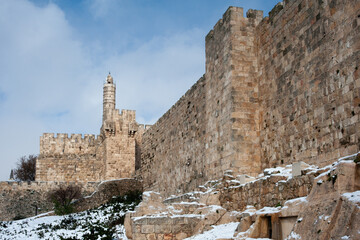 Following a light winter storm in Jerusalem, snow collects on the ground and walls beside the prominent Tower of David minaret along the Old City walls. © Yehoshua Halevi