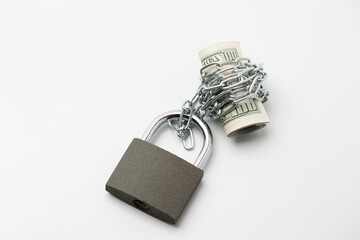 Currency roll locked with chain and padlock on the white background