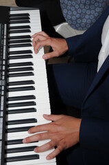 Fototapeta na wymiar hands of musician playing keyboard ,Artist hands of a piano player