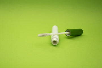 Cosmetic tube on a green background