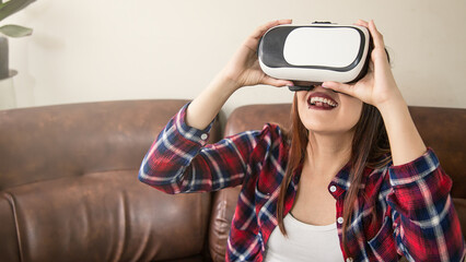 young latin woman watching through virtual reality glasses at home