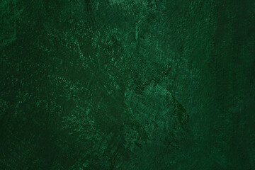 Dark green colored abstract textured background. Decorative plaster on the wall