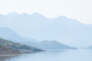 Fototapeta na wymiar Scenic view of calm lake waters and mountains range