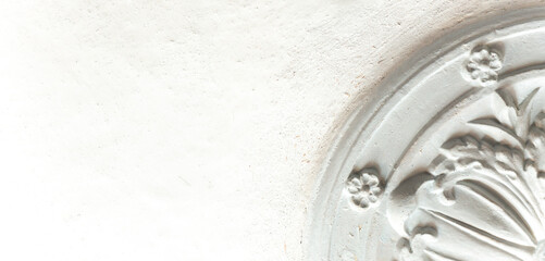 Figured clay molding on the ceiling. White color. Concept: repair, construction, decoration