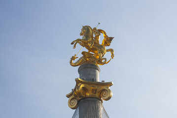 Fototapeta na wymiar Freedom Square with golden statue of St George on tall stone column in Tbilisi, Georgia 