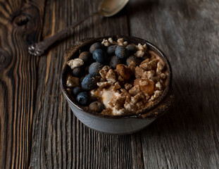 Breakfast bowl with yogurt, puffed brown rice, blueberries, pumkin and cinnamon
