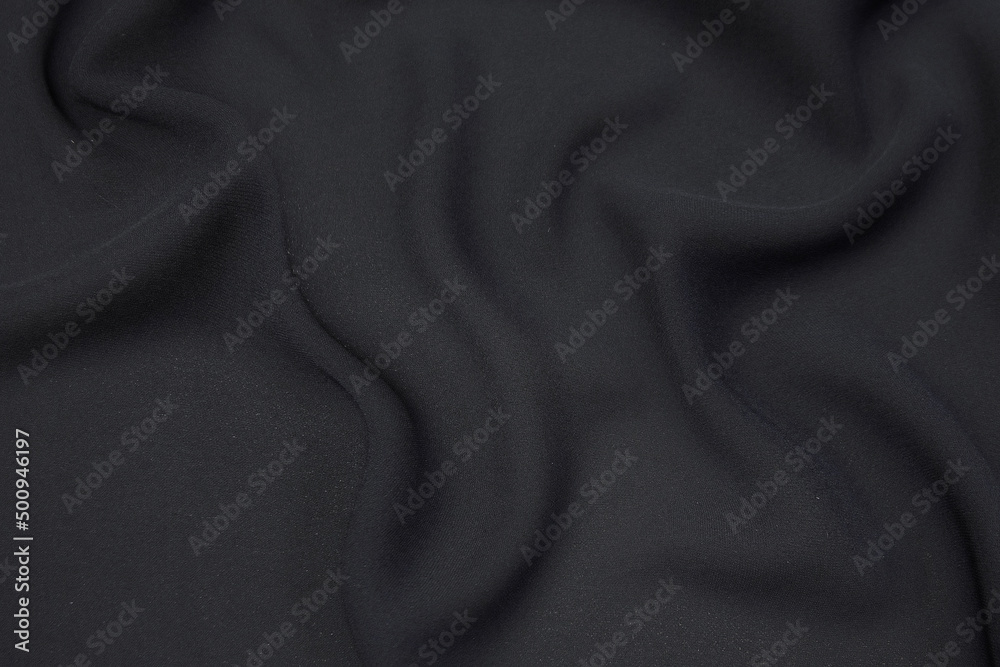 Wall mural silk or cotton fabric tissue. dark gray or black color. texture, background, pattern.