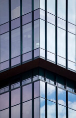 Architectural details of modern office building with reflections.