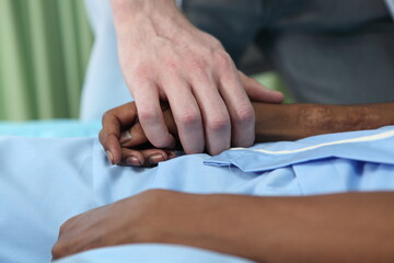 Closeup of  holding hands while sick , Hand of doctor touching old woman in hospital