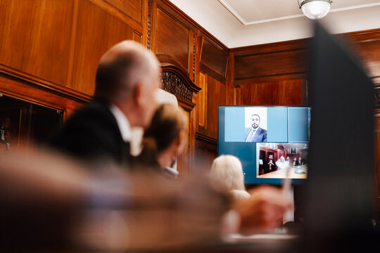 Business colleagues on video conference call with CEO in board room - Powered by Adobe