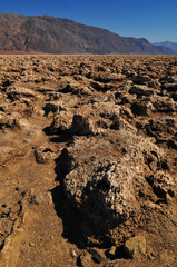 The harsh badlands known as the Devil's Golfcourse, a flat expanse of rock salt eroded by wind and...