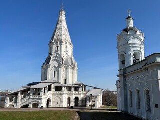 White Russian orthodox church in the park, blue sky, façade of the monastery
