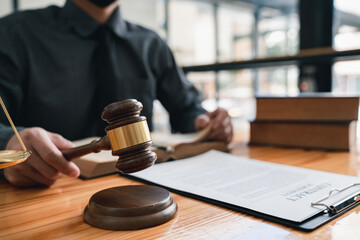 Lawyer or judge holding Hammer prepares to judge the case with justice, and litigation, scales of justice, law hammer,  Legal consulting services, Concept of litigation, and legal services.