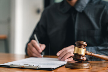 Lawyer man holding pen with contract or agreement document to the customer for signing in courtroom...