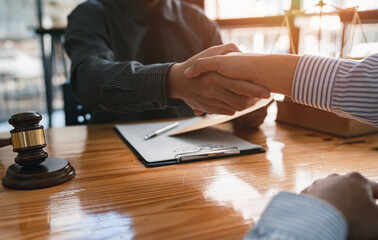 lawyer or judge shaking hands after agreeing to accept a bribe From businessman to lawsuit to win...