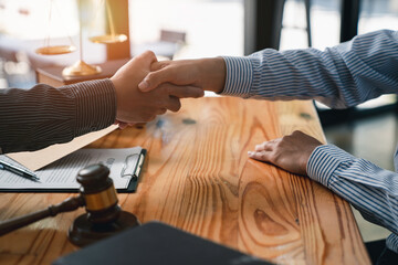 lawyer or judge shaking hands after agreeing to accept a bribe From businessman to lawsuit to win legal, illegal bribery, bribery and corruption concept. - obrazy, fototapety, plakaty