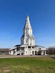 White Russian orthodox church in the park, blue sky, façade of the monastery