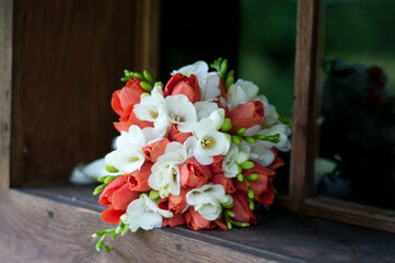  Gold Wedding Ring and  bridal  Bouquet in a windows