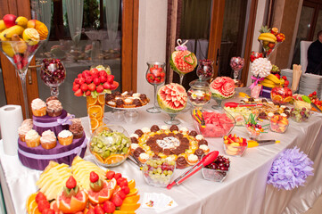 table with  cakes and fruit at  wedding 