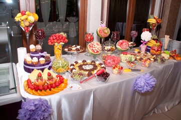 table with  cakes and fruit at  wedding 