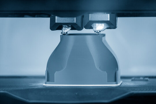 The additive manufacturing by double nozzle 3D printer machine.