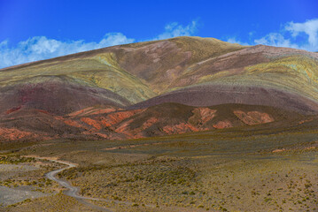 A dirt road winding through colorful mountains on the western slopes of the Cuesta de Lipán...