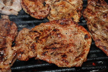 pork steak meat on bbq grill pan and potatoes, home made