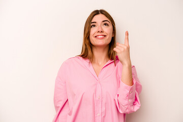 Young caucasian woman isolated on white background indicates with both fore fingers up showing a blank space.