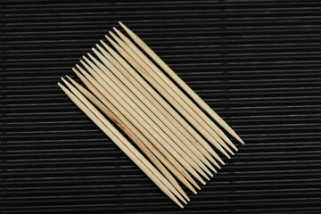 aligned toothpicks   on black ,