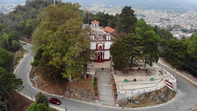 Aerial Drone shot of Church Iglesia de San Cristobalito on the mountain in San Cristobal de Las Casas, Chiapas, Mexico
