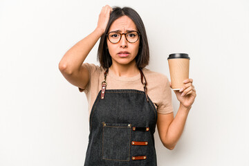 Young caucasian waitress woman holding take away coffee isolated on white background being shocked,...