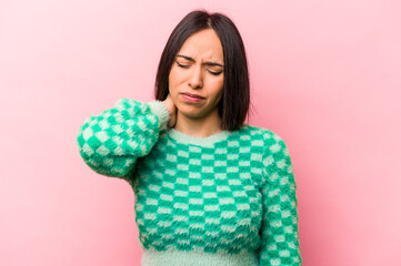 Young hispanic woman isolated on pink background having a neck pain due to stress, massaging and touching it with hand.