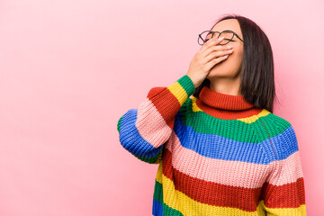 Young hispanic woman isolated on pink background laughing happy, carefree, natural emotion.