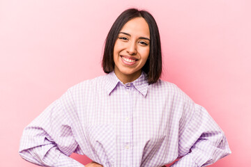 Fototapeta premium Young hispanic woman isolated on pink background happy, smiling and cheerful.