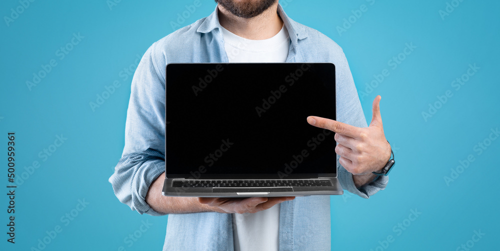 Poster cropped of man holding laptop computer with empty screen