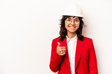 Young architect hispanic woman with helmet isolated on white background smiling and raising thumb up
